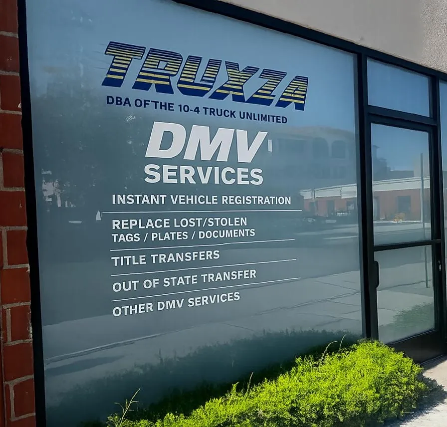 The Truxza storefront, with the DMV services, notary public and insurance listed on the office window